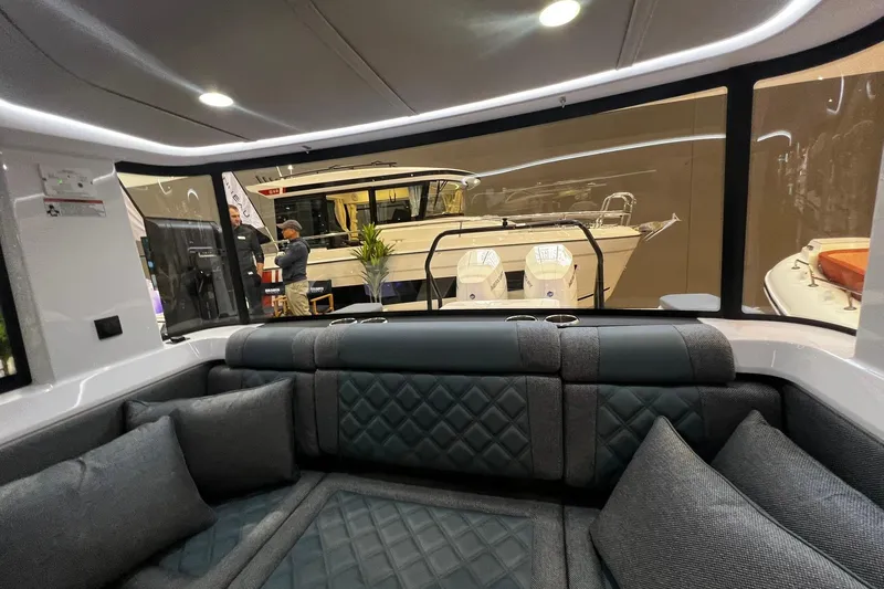 Slide: The Image of Interior view of 2026 Axopar 37 XC Cross Cabin with luxurious seating and large windows. - 33