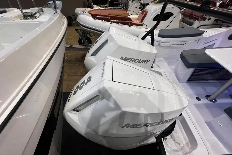 Slide: The Image of 2026 Axopar 37 XC Cross Cabin with twin Mercury outboard engines. - 38