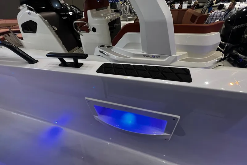 Slide: The Image of 2026 Axopar 37 XC Cross Cabin boat interior with blue LED lighting and seating. - 5