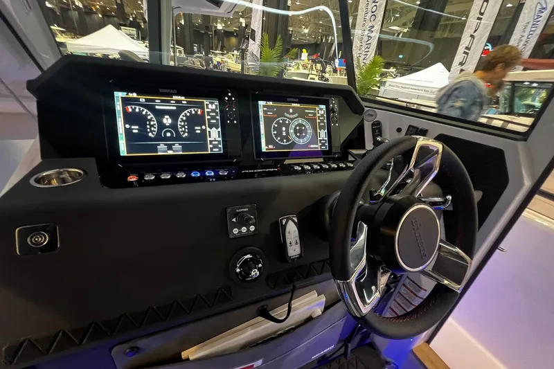Slide: The Image of Interior view of 2026 Axopar 37 XC Cross Cabin with advanced dashboard and steering wheel. - 6