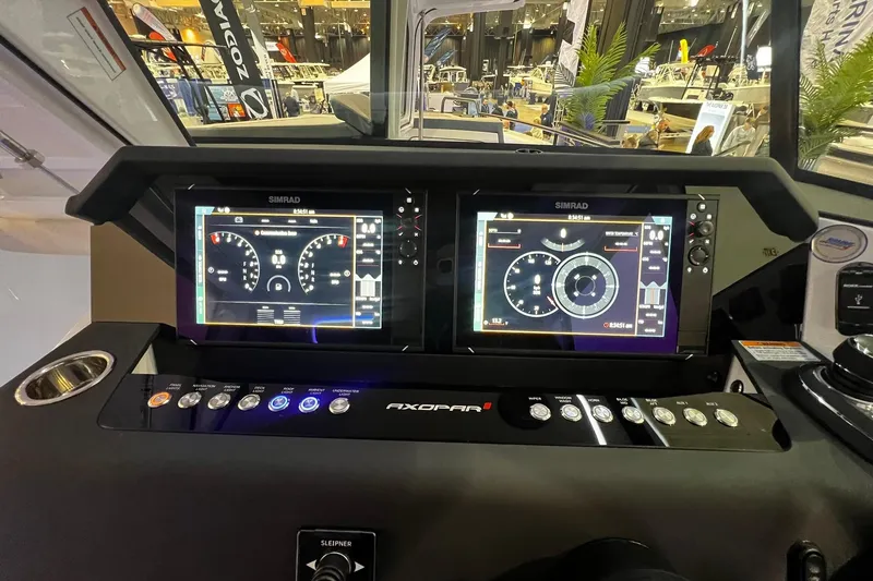 Slide: The Image of Control panel of 2026 Axopar 37 XC Cross Cabin with dual Simrad displays. - 7