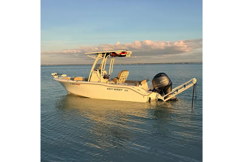 The Image of 2023 Key West 219 FS boat on calm water at sunset. - 0