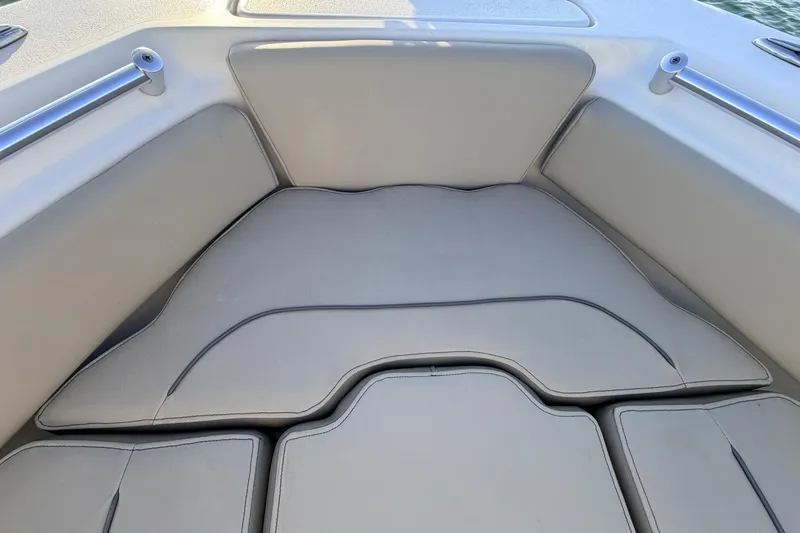 Slide: The Image of 2023 Key West 219 FS boat interior with cushioned seating area. - 10