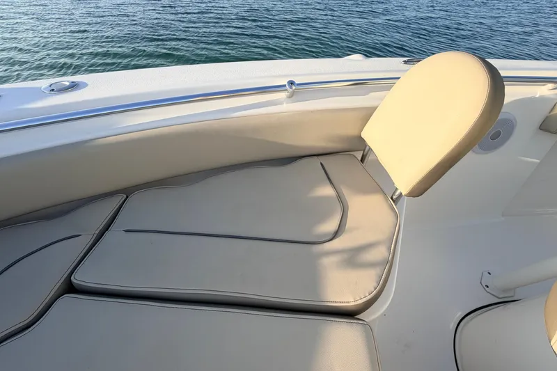 Slide: The Image of 2023 Key West 219 FS boat interior with beige seating and ocean view. - 11