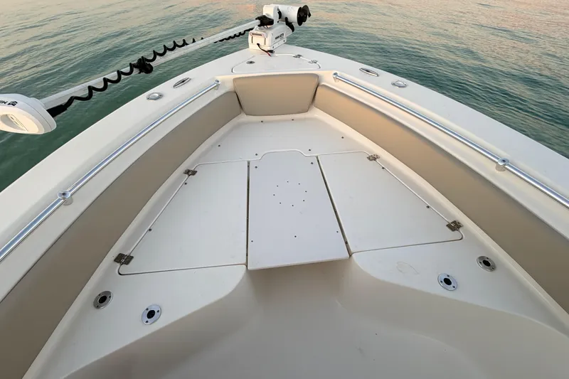 Slide: The Image of 2023 Key West 219 FS boat bow with trolling motor on calm water. - 16