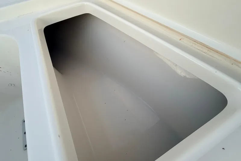 Slide: The Image of Storage compartment of 2023 Key West 219 FS boat, featuring a clean, white interior. - 21