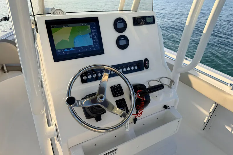 Slide: The Image of 2023 Key West 219 FS boat console with steering wheel and navigation display. - 26