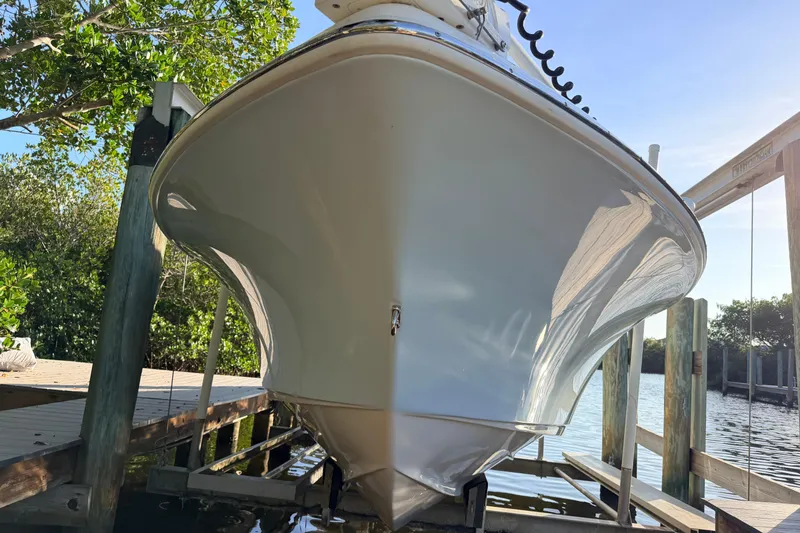 Slide: The Image of 2023 Key West 219 FS boat on a lift, dockside view. - 3