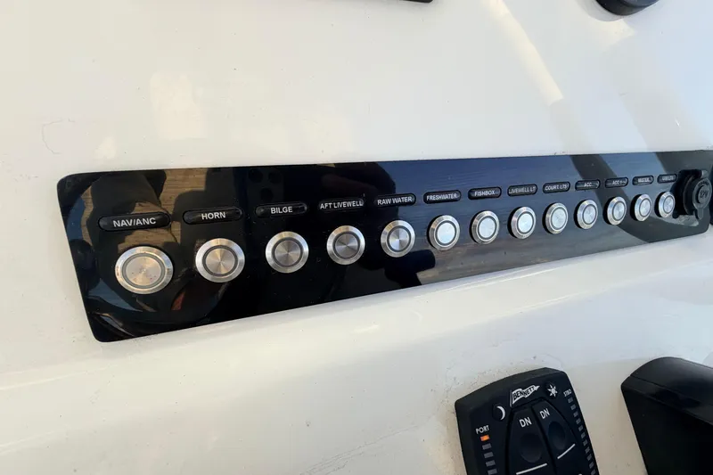 Slide: The Image of Control panel of 2023 Key West 219 FS boat with labeled buttons and switches. - 31