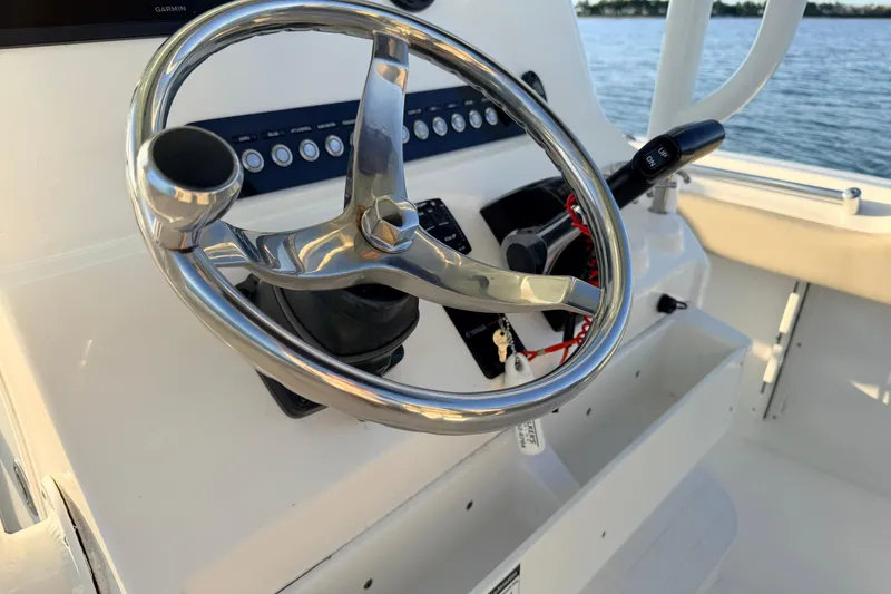 Slide: The Image of 2023 Key West 219 FS boat steering wheel and control panel, on calm water. - 33