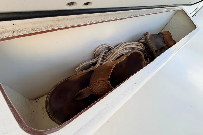 Slide: The Image of Storage compartment in 2023 Key West 219 FS boat with sandals and rope. - 35