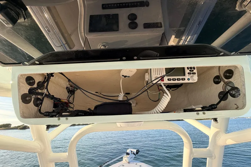 Slide: The Image of 2023 Key West 219 FS boat console with electronic equipment and wiring. - 39