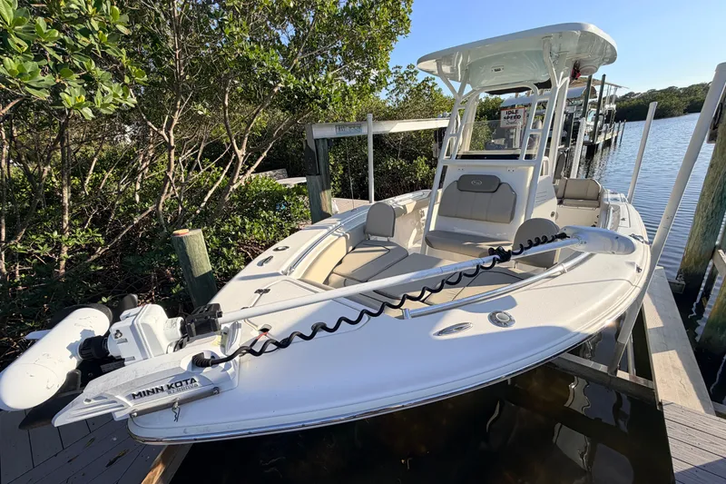 Slide: The Image of 2023 Key West 219 FS boat docked by the water, featuring Minn Kota trolling motor. - 4