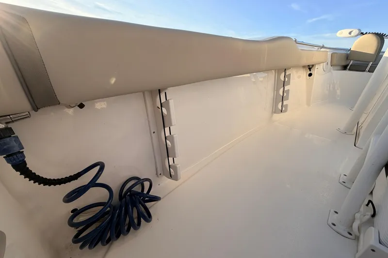 Slide: The Image of 2023 Key West 219 FS boat interior with coiled hose and seating. - 41