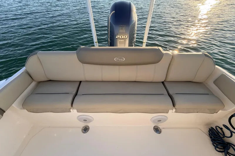 Slide: The Image of 2023 Key West 219 FS boat with cushioned seating and Yamaha engine on water. - 44