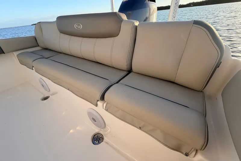 Slide: The Image of 2023 Key West 219 FS boat with comfortable beige seating and ocean backdrop. - 46