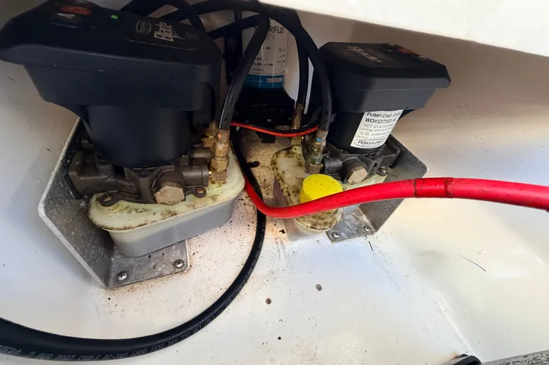 Slide: The Image of 2023 Key West 219 FS boat components with wiring and pumps in close-up view. - 52