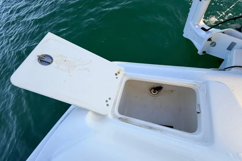 Slide: The Image of Open storage compartment on 2023 Key West 219 FS boat, near water. - 55