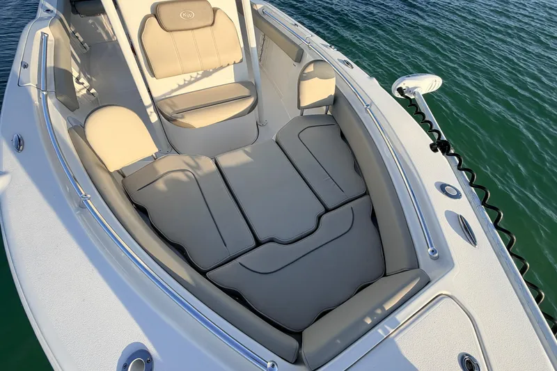 Slide: The Image of 2023 Key West 219 FS boat interior with cushioned seating on water. - 6