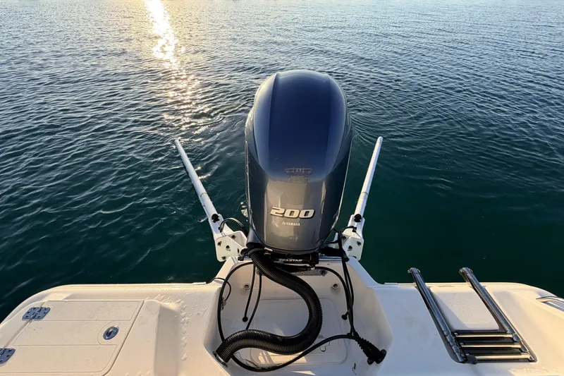 Slide: The Image of 2023 Key West 219 FS boat with Yamaha 200 engine on calm water. - 61