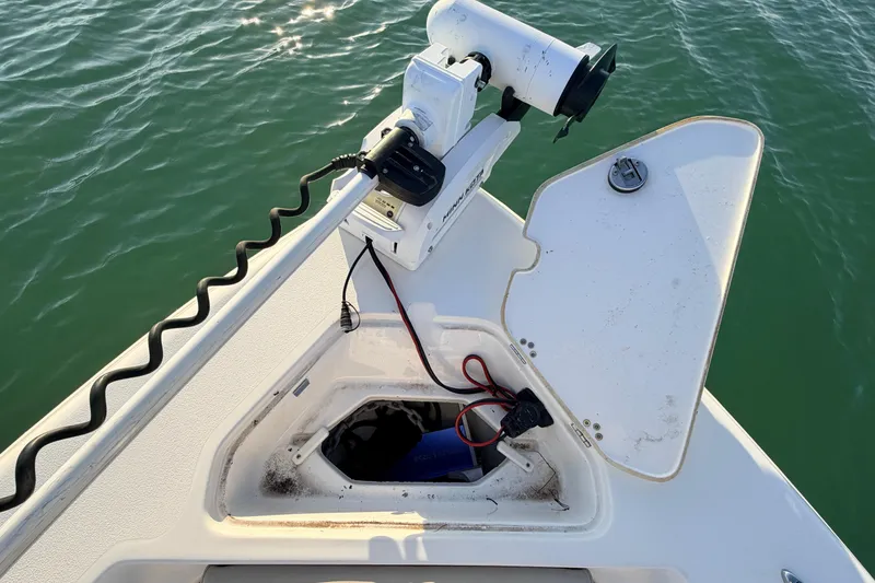 Slide: The Image of 2023 Key West 219 FS boat with open hatch and mounted equipment on calm water. - 8