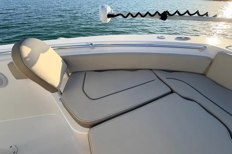 Slide: The Image of 2023 Key West 219 FS boat interior with cushioned seating, overlooking calm water. - 9
