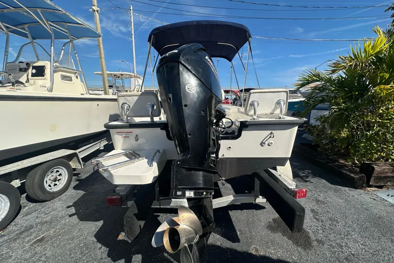 Slide: The Image of 2021 Boston Whaler 170 Montauk boat with outboard motor, parked on a trailer. - 3