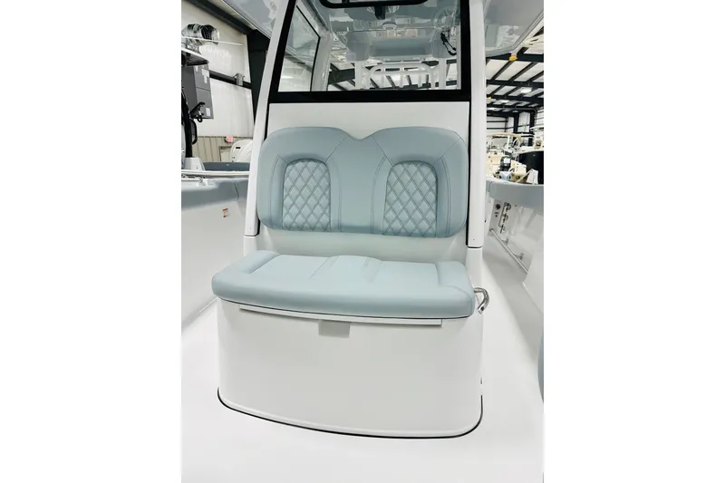 Slide: The Image of 2026 Sportsman Open 302 Center Console boat seat with light blue upholstery. - 12