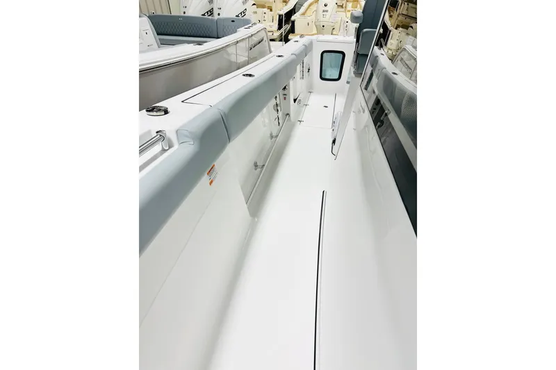 Slide: The Image of 2026 Sportsman Open 302 Center Console boat interior, showcasing sleek white deck design. - 14