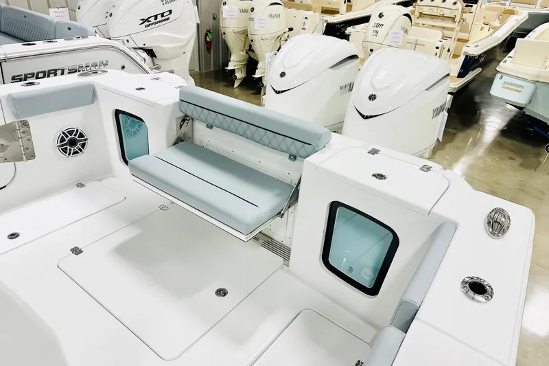 Slide: The Image of 2026 Sportsman Open 302 Center Console boat interior with seating and Yamaha engines. - 16