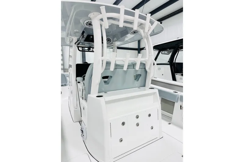 Slide: The Image of 2026 Sportsman Open 302 Center Console boat interior with rod holders and storage compartments. - 5