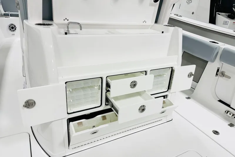 Slide: The Image of 2026 Sportsman Open 302 Center Console with open storage compartments and drawers. - 6