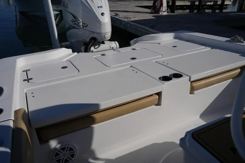 Slide: The Image of 2023 Sportsman Masters 267 Bay Boat deck with storage compartments and Yamaha outboard motor. - 18
