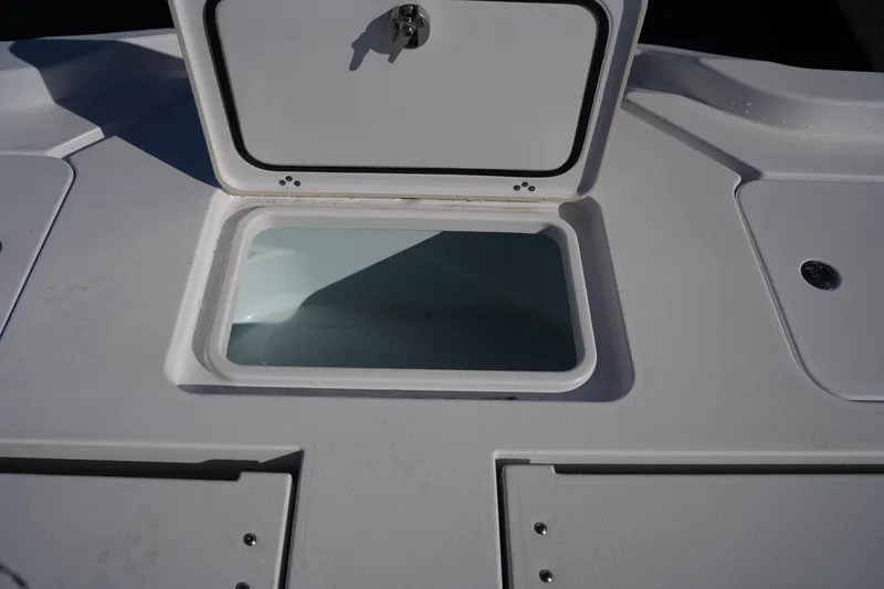 Slide: The Image of 2023 Sportsman Masters 267 Bay Boat storage compartment with open hatch. - 20