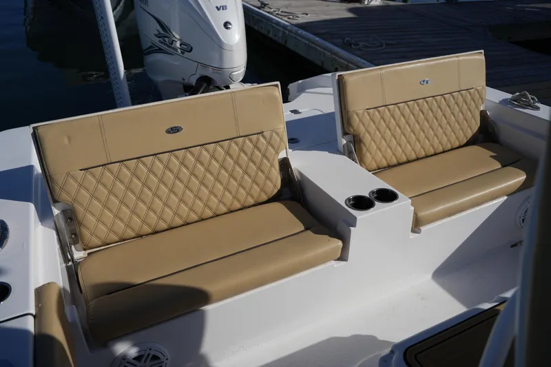 Slide: The Image of 2023 Sportsman Masters 267 Bay Boat seating with tan upholstery and cup holders. - 22