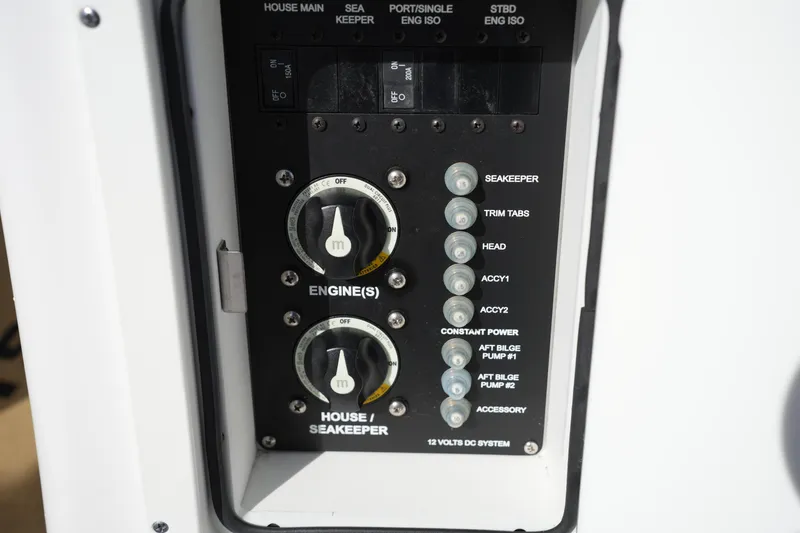 Slide: The Image of Control panel of 2023 Sportsman Masters 267 Bay Boat with various switches and dials. - 24