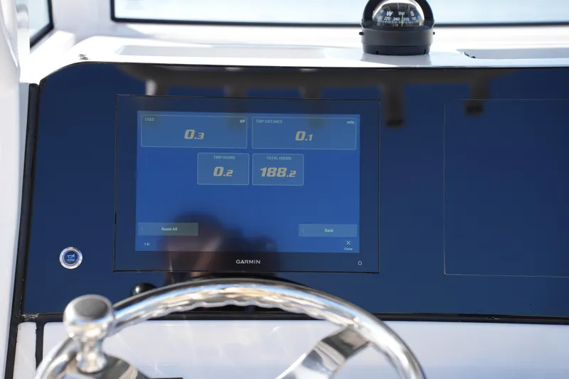 Slide: The Image of 2023 Sportsman Masters 267 Bay Boat dashboard with Garmin display and compass. - 28