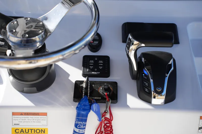 Slide: The Image of 2023 Sportsman Masters 267 Bay Boat dashboard with steering wheel and controls. - 29