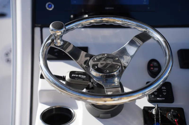 Slide: The Image of Steering wheel of 2023 Sportsman Masters 267 Bay Boat with pro-trim control. - 30