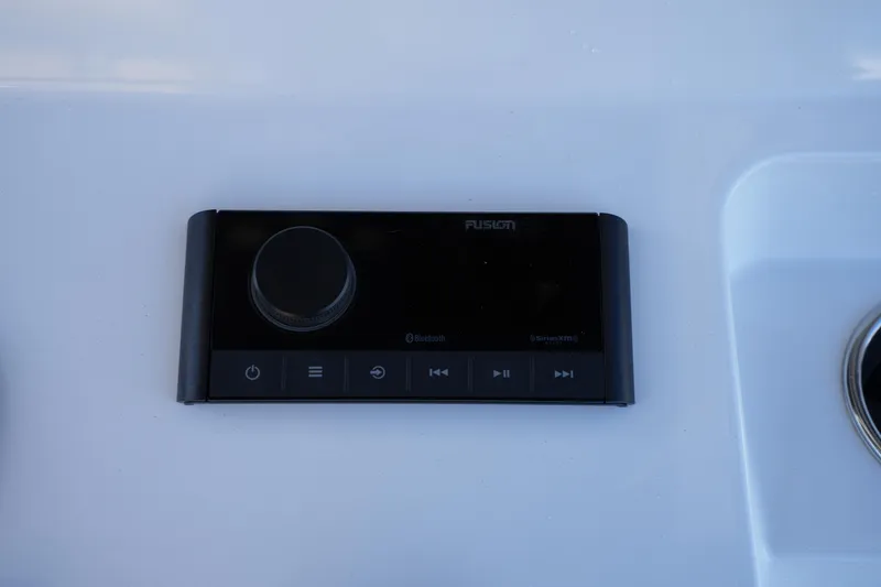 Slide: The Image of Fusion audio control panel on 2023 Sportsman Masters 267 Bay Boat dashboard. - 34