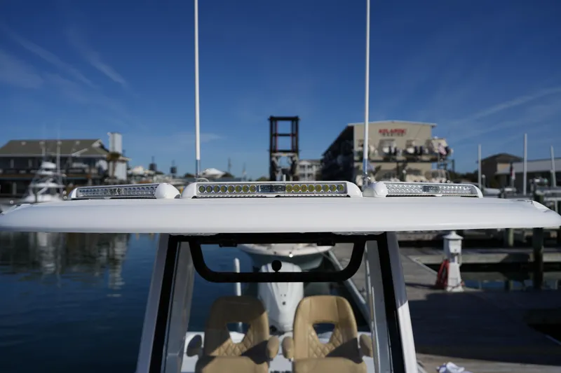 Slide: The Image of 2023 Sportsman Masters 267 Bay Boat at marina, featuring rooftop LED lights. - 37