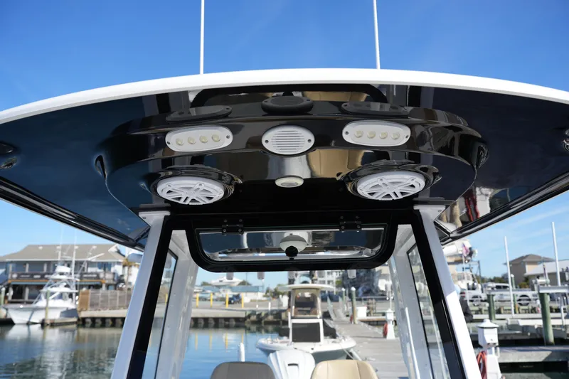 Slide: The Image of 2023 Sportsman Masters 267 Bay Boat T-top with speakers and lights at marina. - 38