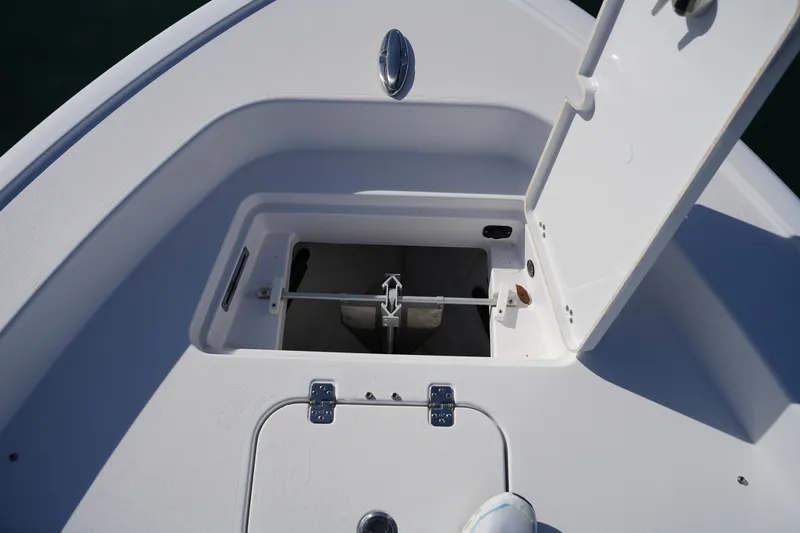 Slide: The Image of 2023 Sportsman Masters 267 Bay Boat anchor storage compartment with open hatch. - 45