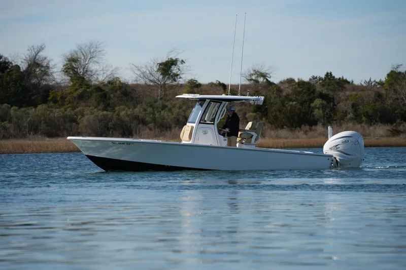Slide: The Image of 2023 Sportsman Masters 267 Bay Boat cruising on calm water. - 8