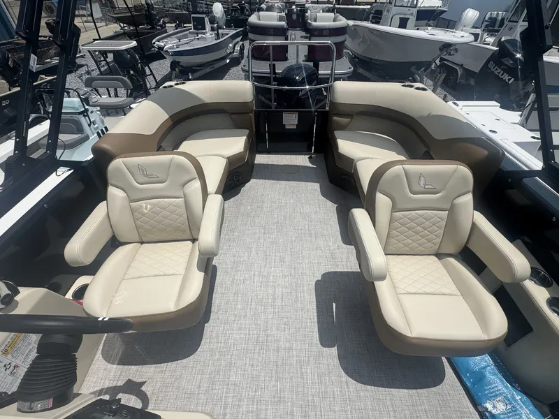 Slide: The Image of The image shows the interior of a 2026 Lowe LS Walk Thru 210 boat with beige leather seats. - 6