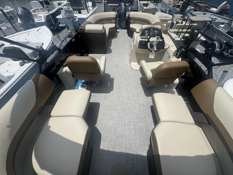 Slide: The Image of The image shows the interior of a 2026 Lowe LS Walk Thru 210 boat with beige seating. - 10