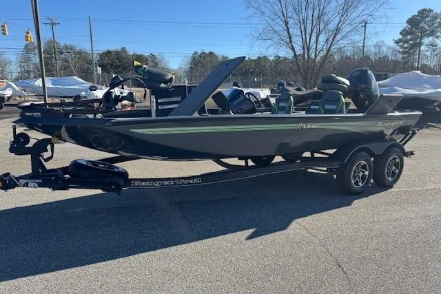 The Image of 2025 Ranger RT198P fishing boat on trailer, parked outdoors in sunny weather. - 1
