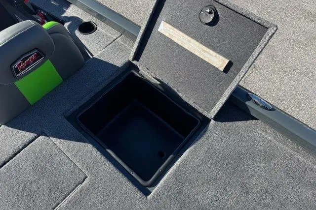 Slide: The Image of 2025 Ranger RT198P boat storage compartment with open lid, gray interior, and seat detail. - 13