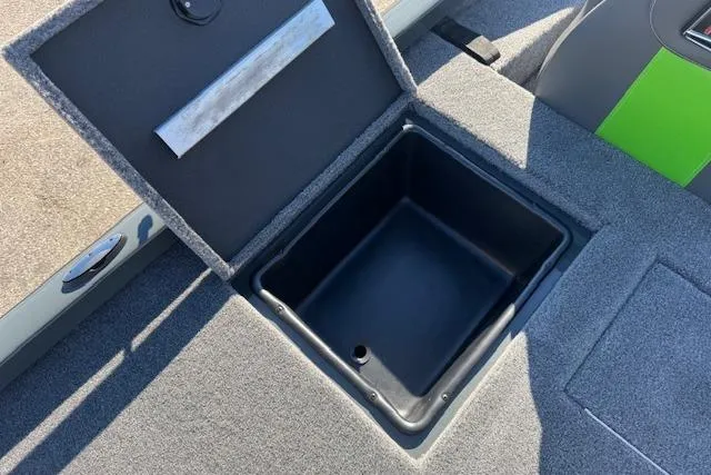 Slide: The Image of Open storage compartment in 2025 Ranger RT198P boat, featuring a carpeted interior. - 14