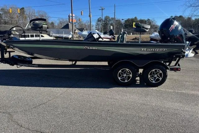 Slide: The Image of 2025 Ranger RT198P fishing boat on trailer, parked outdoors. - 3